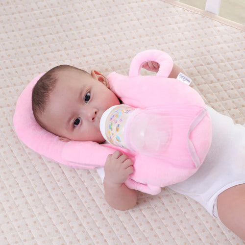 "Modèle rose du BibSupport™ - Coussin d'alimentation confortable permettant à bébé de boire seul son biberon"